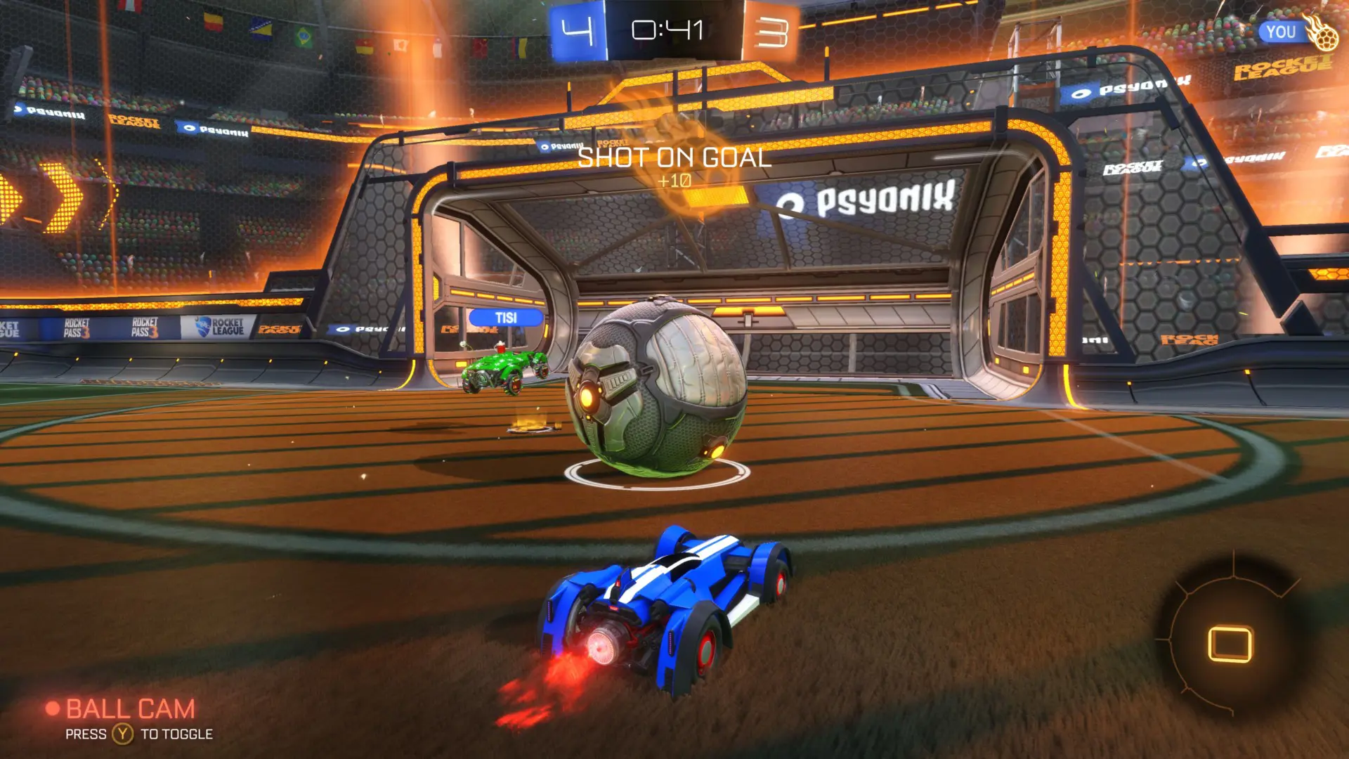 A gameplay screenshot from Rocket League of a player taking a shot on goal