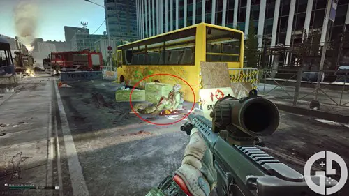 Image of the yellow bus with a dead Scav at the Ground Zero Mira Ave extract in Escape from Tarkov