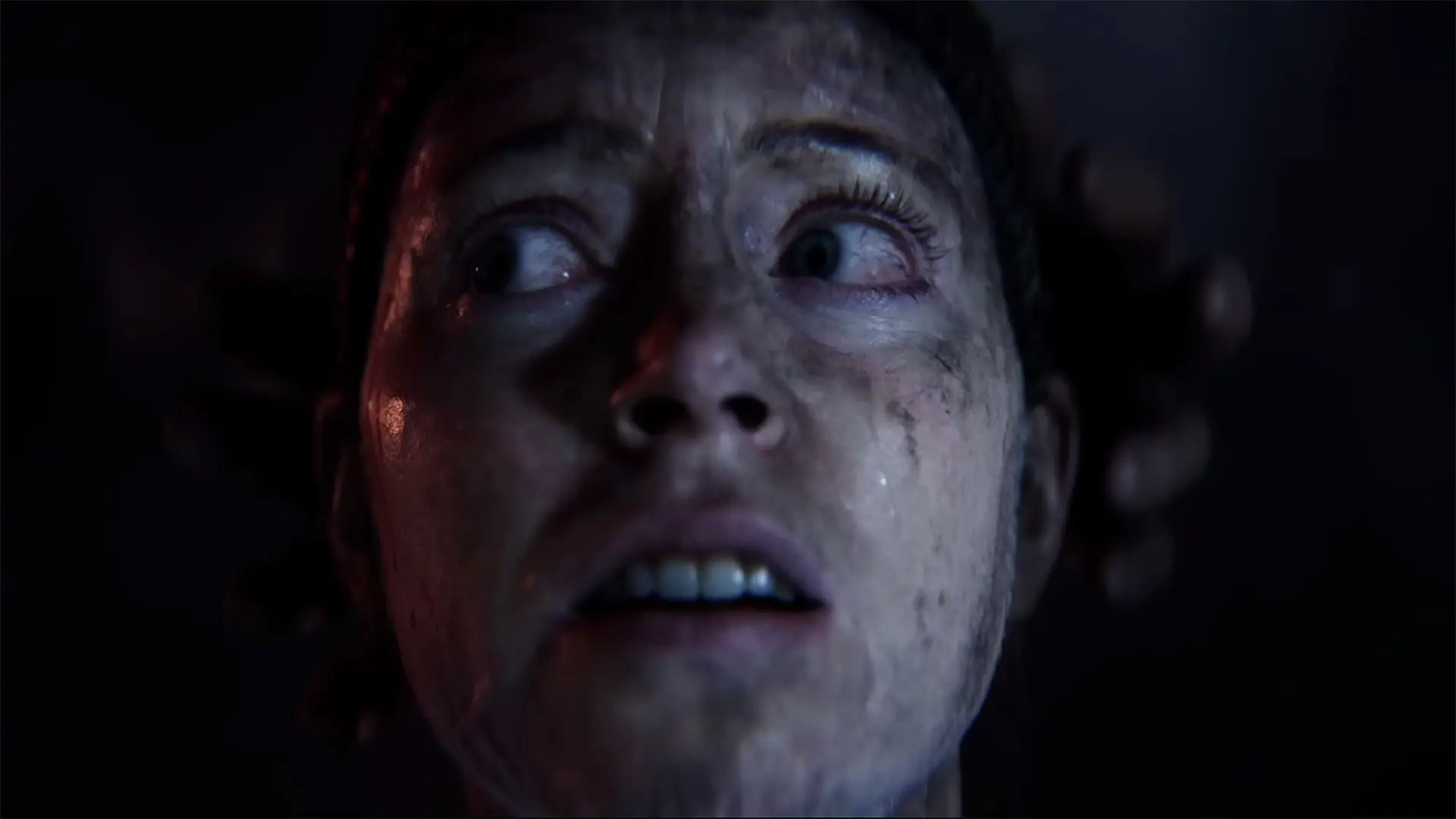 Senua, frightened and muddied in Hellblade: Senua's Sacrifice.