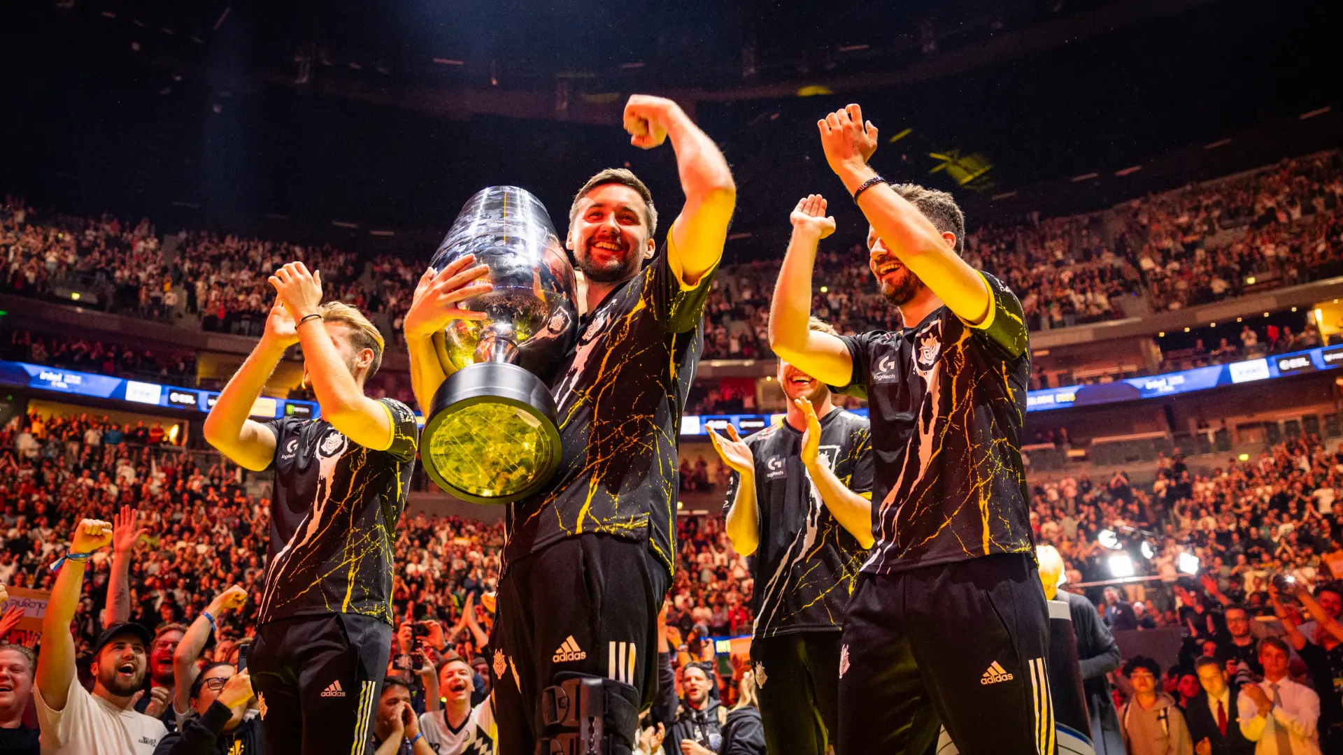 hooxi holding trophy with team on stage