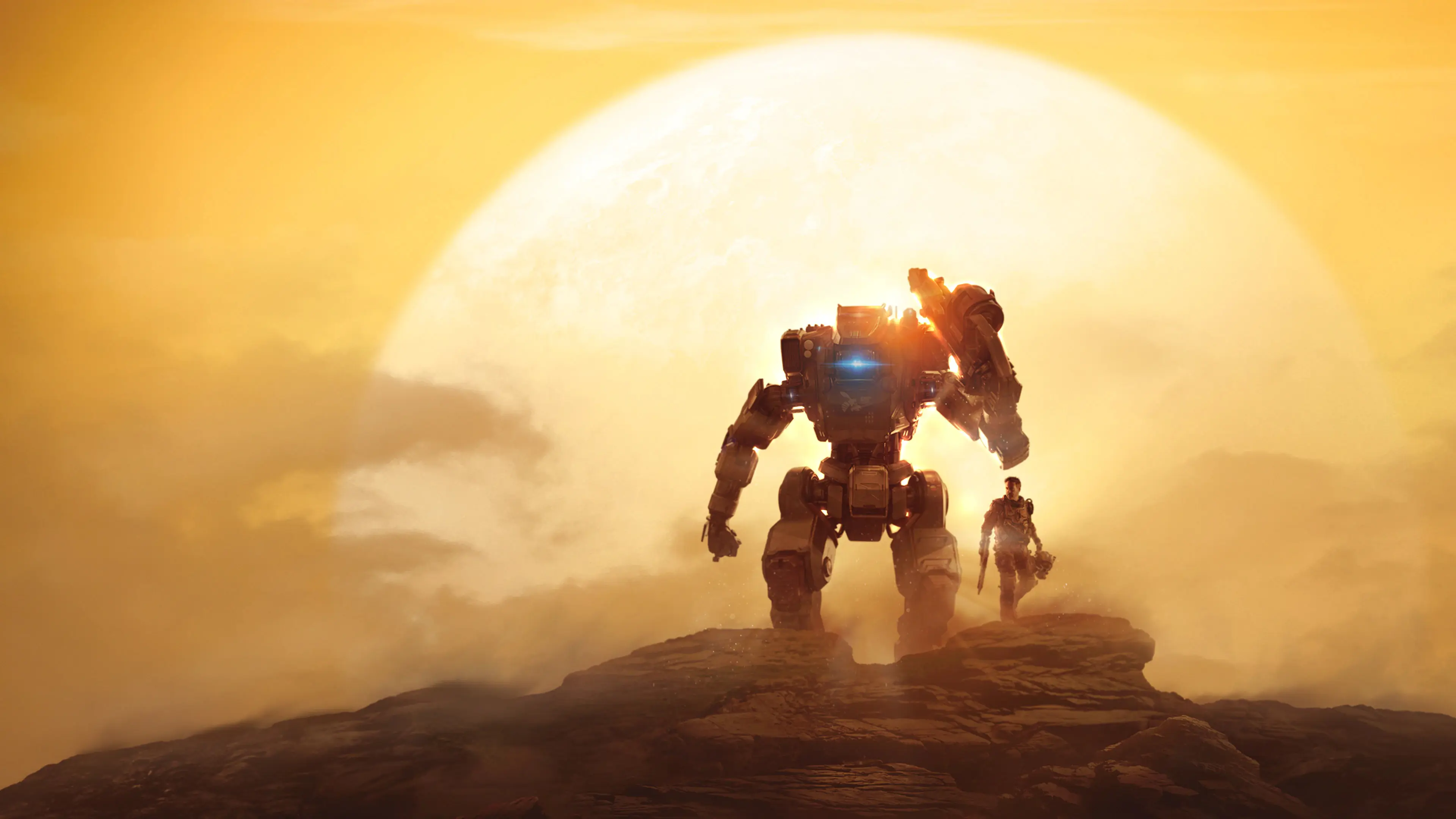 A pilot and their mech stand before a sunset in key art for Titanfall 2.