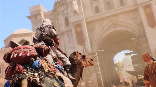 The player character in Assassin's Creed Mirage riding a camel into a city