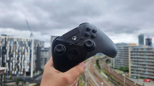 ASUS ROG Raikiri Pro controller held over a city