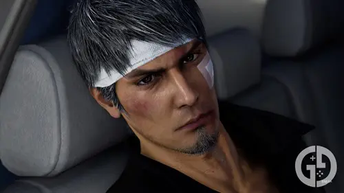 Kiryu with several bandages on his face, sitting in the back of a car